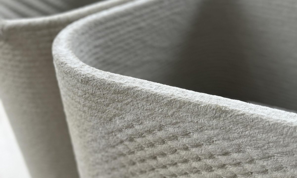 Close-up of printed precast planters showing the layered surface texture